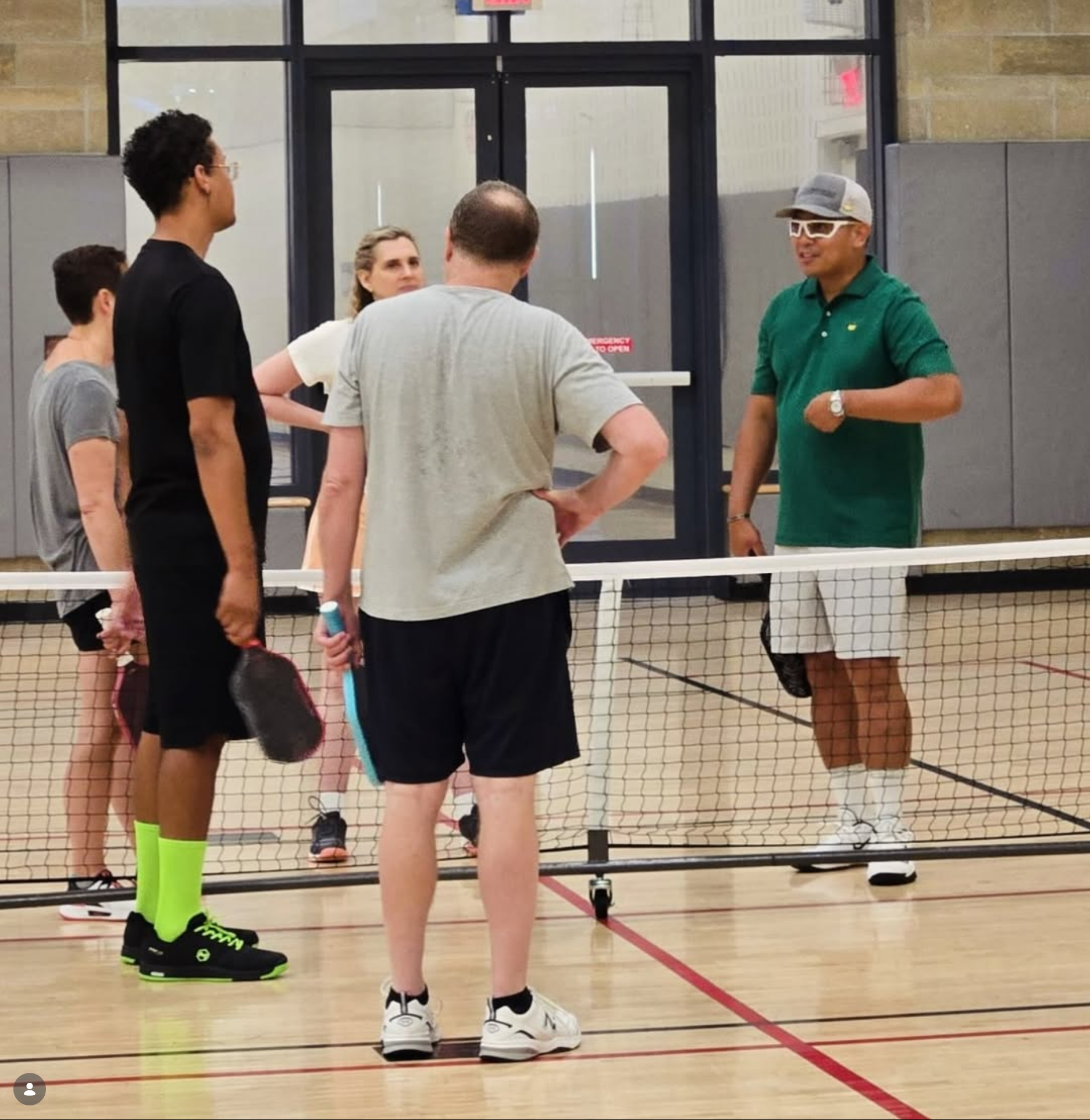 Coach Ronnie instructing a group at the net