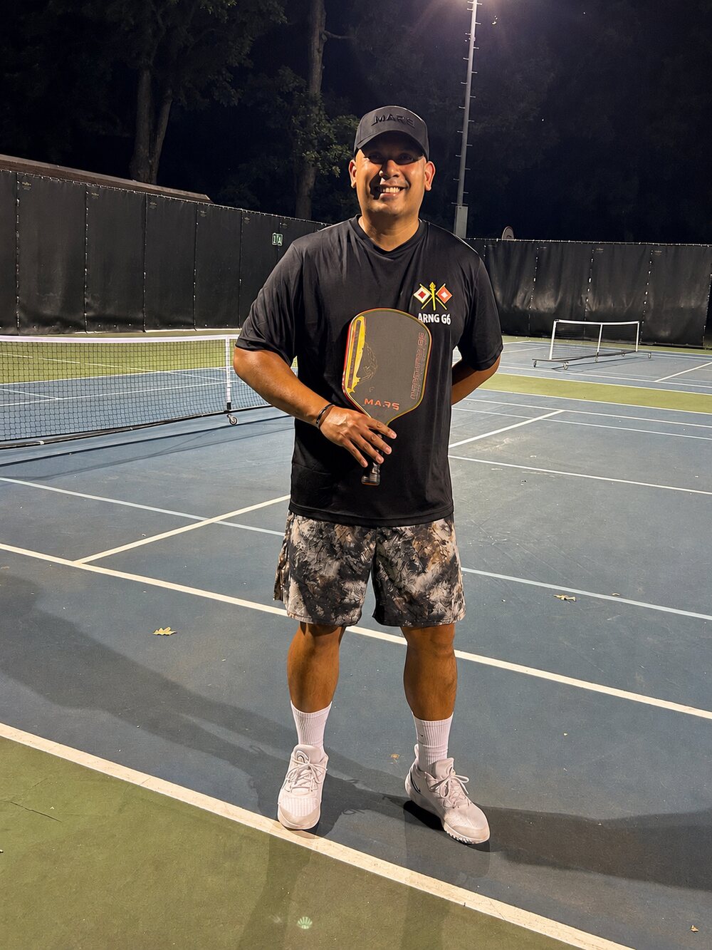 Coach Ronnie Vengua on the pickleball court with his Mars paddle
